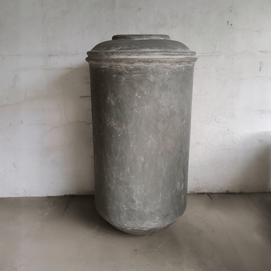 Vintage-style gray cylindrical container against a plain background