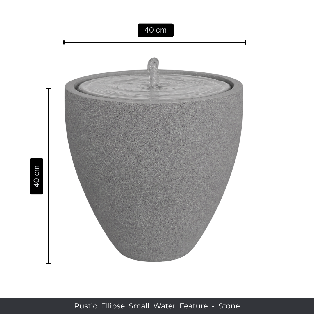 The Florastyle By Hingham Water Feature - Rustic Ellipse Small is a round, gray stone piece (40 cm high/wide) with a gentle top spout. Its smooth surface and subtle ripple effect make it ideal for indoor or outdoor spaces.