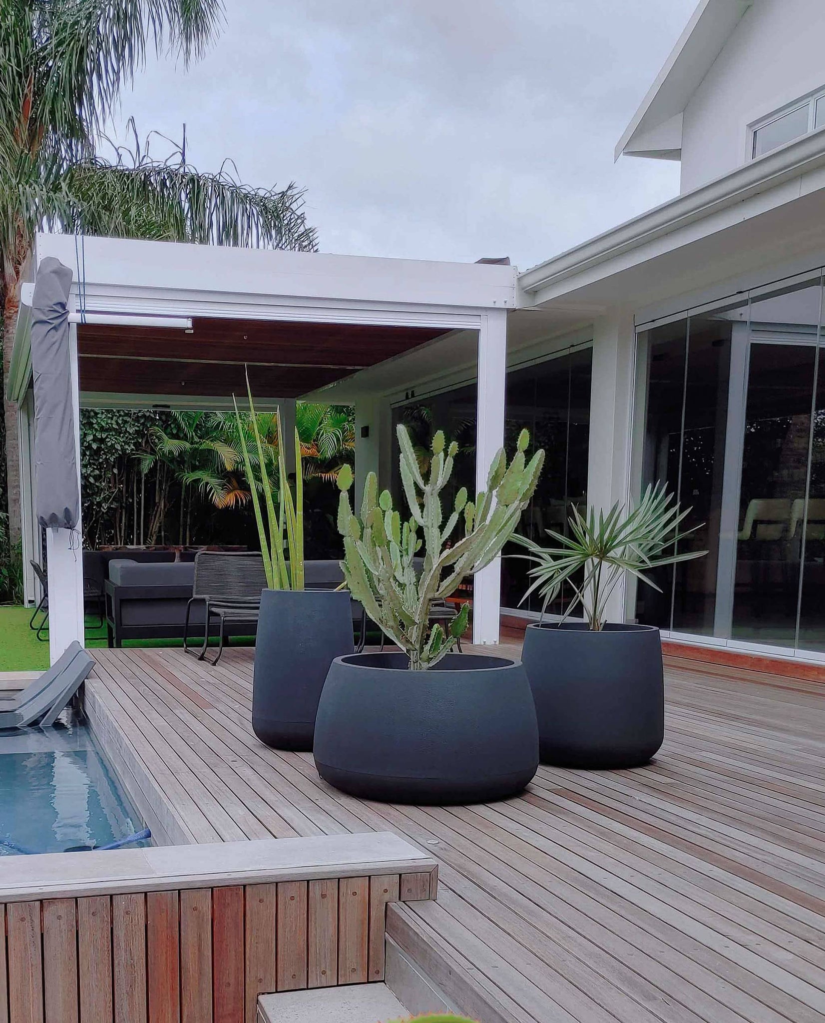 Fabulous planters, Bios Japi planters in the colour lead sold by Florastyle by Hingham. Styled on a wooden deck next to the swimming pool. Modern Contempory style. Sort after set of 3. 
