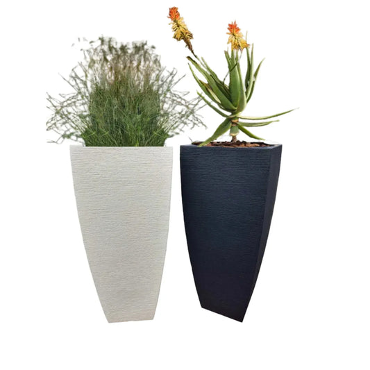 Off White and lead modern textured polyresin planters with plants. Placed next to each other.