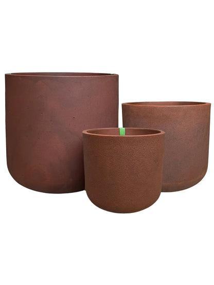 Three corten steel-colored planters of different sizes on a white background. Large, medium and small.