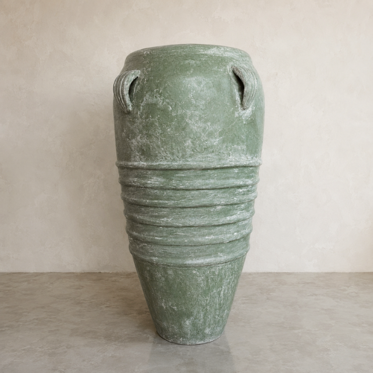 The Athens Organic Fiberglass Pot - Earth Range by Florastyle By Hingham features a large green weathered finish, dual small top handles, and horizontal mid-ridges. It sits on a smooth light-toned surface against a neutral wall.