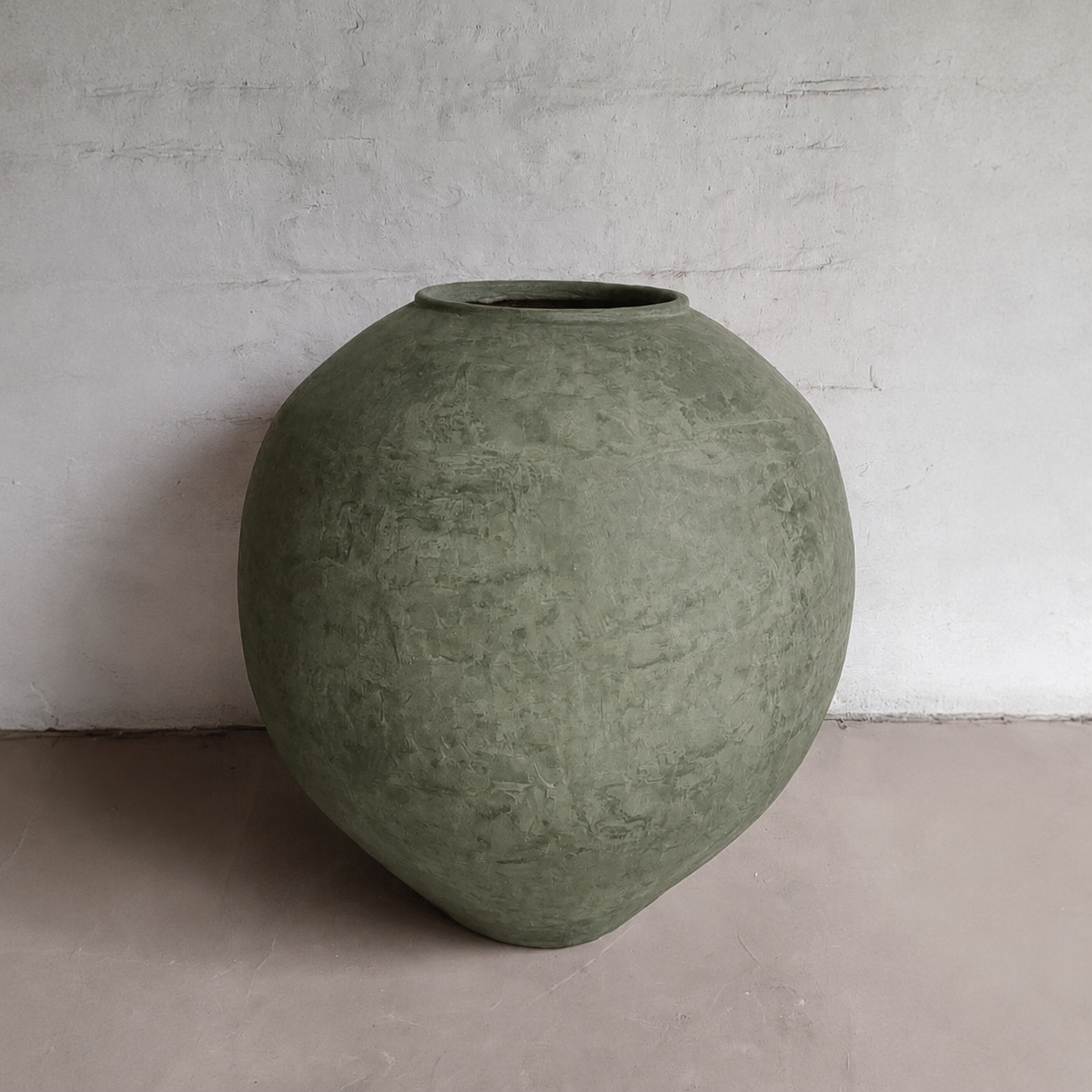 The Syracuse Organic Fiberglass Pot - Earth Range by Florastyle By Hingham is a large, round Mediterranean-style planter with a textured green finish and a small top opening, ideal for indoors and featuring a lightweight, natural look.