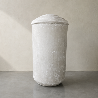The Damascus Organic Fiberglass Pot - Earth Range by Florastyle By Hingham features a tall, textured stone finish and rounded lid, adding a weathered yet minimalist vibe to any modern interior space.