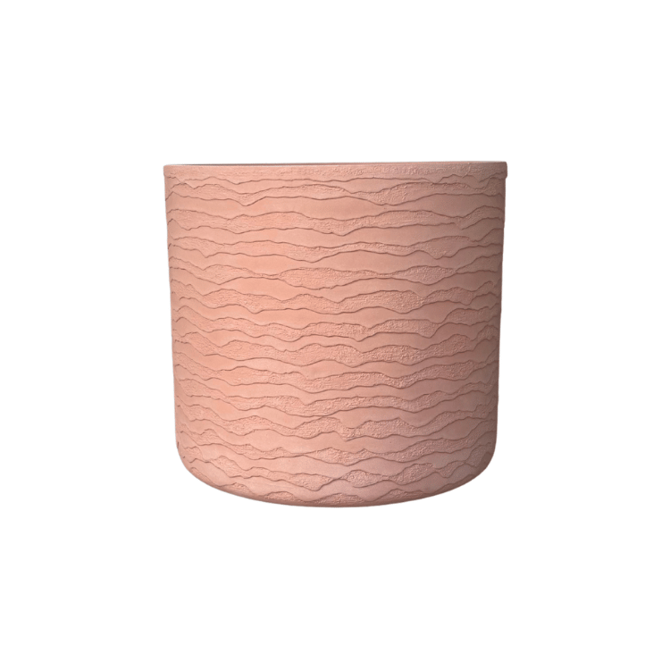 The Florastyle By Hingham Japi Delhi Planter is a round, light pink indoor-outdoor planter featuring a textured, wavy horizontal pattern and shown against a plain white background.