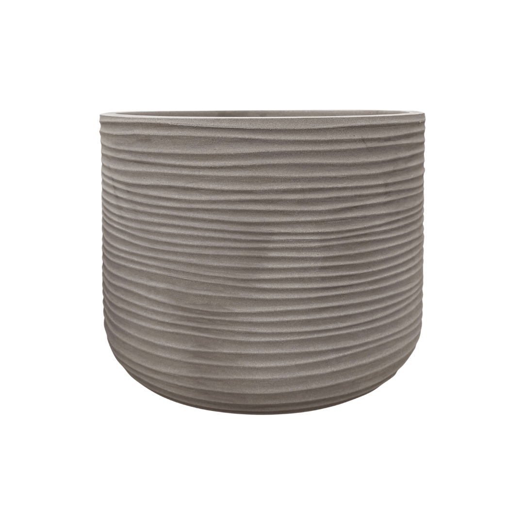 A gray Lagoon Round Japi Planter by Florastyle By Hingham, featuring horizontal textured ridges around its exterior, is displayed against a white background.