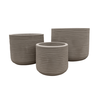 Three round, gray, ribbed Lagoon Round Japi Planters by Florastyle By Hingham in varying sizes are grouped together against a white background, showcasing a sleek and modern planter aesthetic.