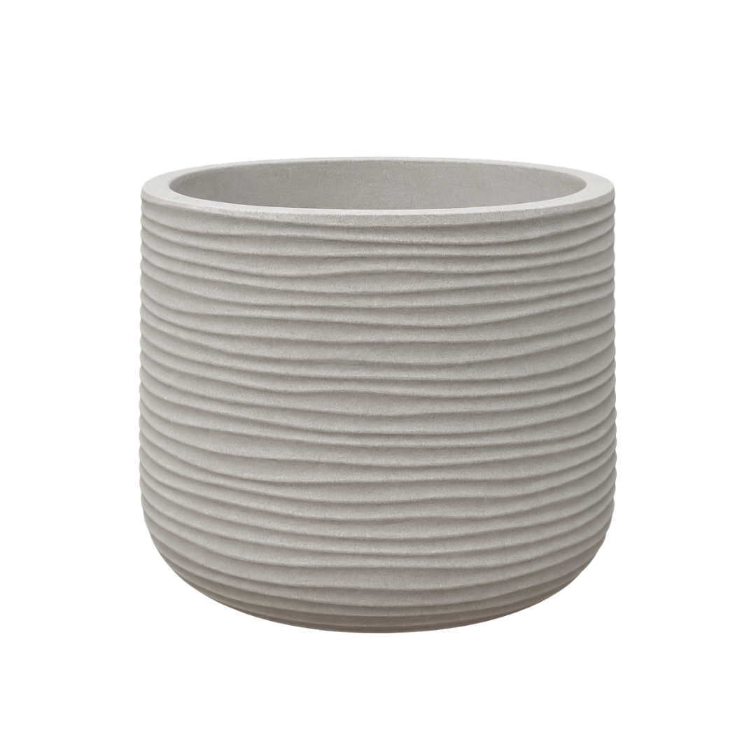 The Lagoon Round Japi Planter by Florastyle By Hingham is a round, light gray planter from the Lagoon Planters collection. It features horizontal ridges, a smooth interior, and is crafted from durable polyresin for a modern aesthetic. Isolated on a white background.