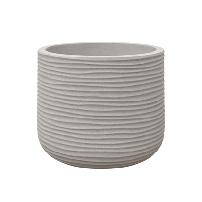 The Lagoon Round Japi Planter by Florastyle By Hingham is a round, light gray planter from the Lagoon Planters collection. It features horizontal ridges, a smooth interior, and is crafted from durable polyresin for a modern aesthetic. Isolated on a white background.