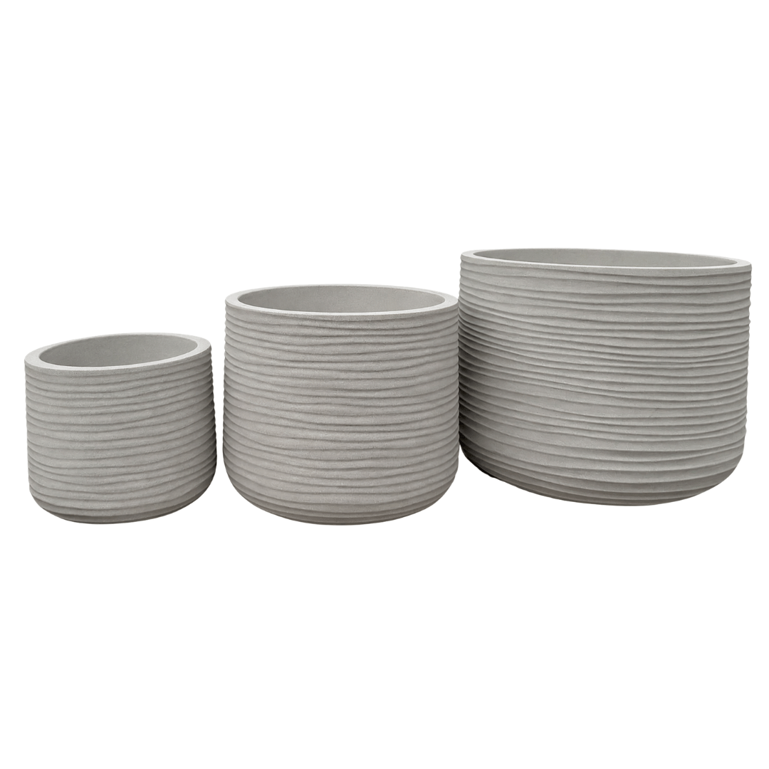 Three gray Lagoon Round Japi Planters by Florastyle By Hingham, each a different size, are displayed side by side. Every planter features a modern design with a textured, horizontal ribbed pattern encircling its surface. The planters are set against a plain white background.