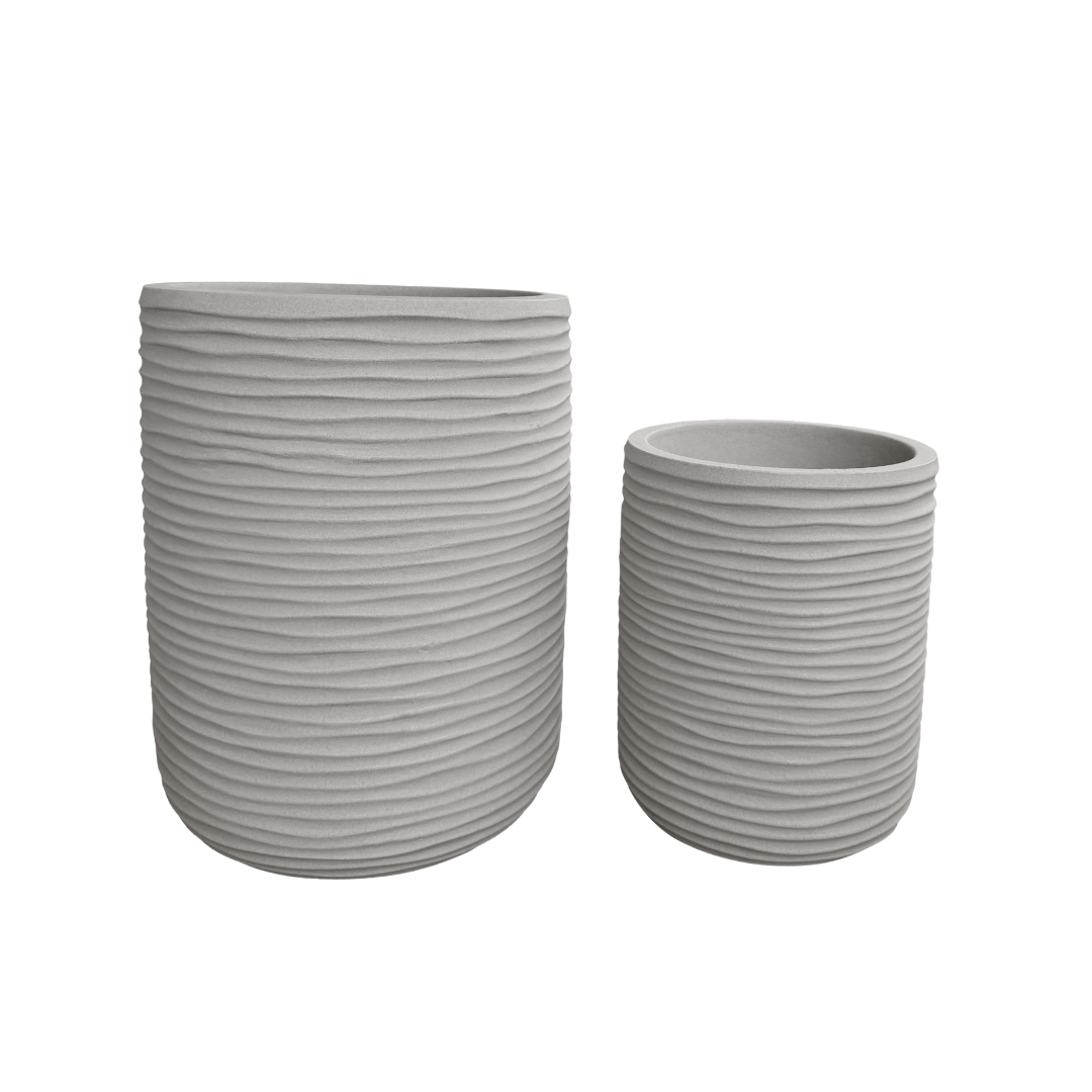Two cylindrical Lagoon Tall Japi Planters by Florastyle By Hingham—one larger and one smaller—feature light gray finishes and horizontal ridges, positioned side by side on a white background. Crafted from lightweight polyresin, these modern planters are both durable and easy to move.