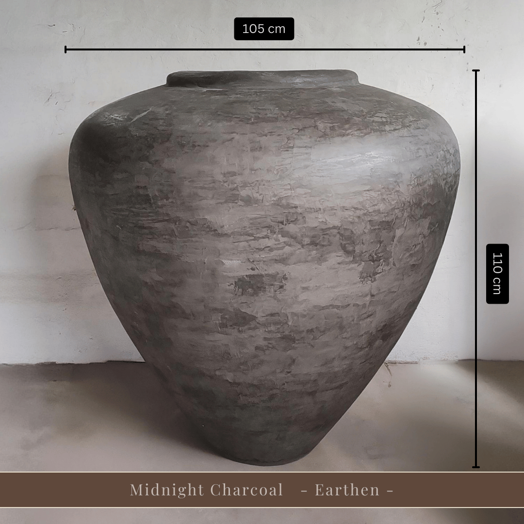 A large, gray Mykonos Organic Fiberglass Pot - Earth Range by Florastyle By Hingham (105 cm W x 110 cm H) stands out with its lightweight build and subtle elegance. Midnight Charcoal - Earthen - is displayed at the bottom.