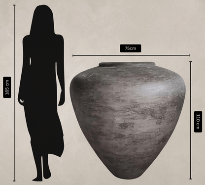 The Mykonos Organic Fiberglass Pot - Earth Range by Florastyle By Hingham (75cm wide, 110cm tall) is pictured beside a 165cm-tall person for scale; despite its impressive size, this pot is surprisingly lightweight.