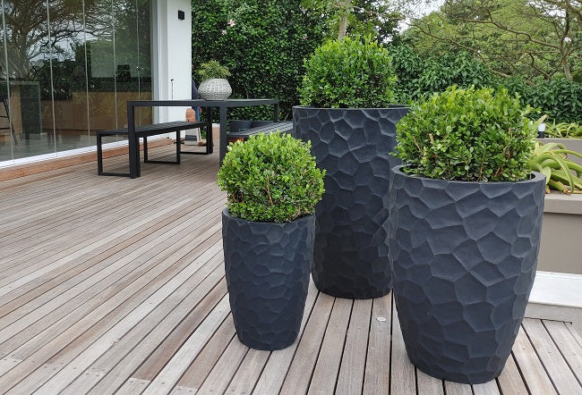 Prisma planters are upright and round with facets to create texture and interest. Available in lead black and off white.