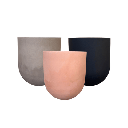 Three modern Traditional Cask Japi Planters from Florastyle By Hingham in light gray, blush pink, and matte black are grouped together against a white background. Made of lightweight polyresin for easy indoor or outdoor placement.