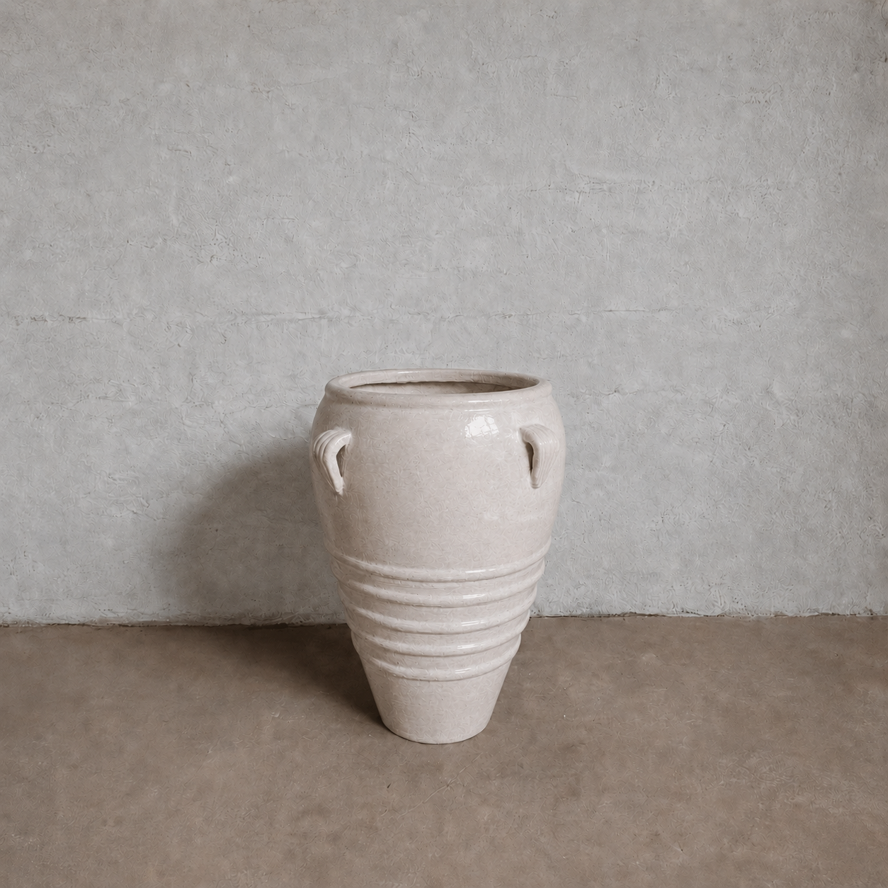 The Athens Organic Fiberglass Pot - Earth Range by Florastyle By Hingham, featuring two handles and horizontal ridges, brings the timeless elegance of ancient Greek pottery to your space with its large light beige design.