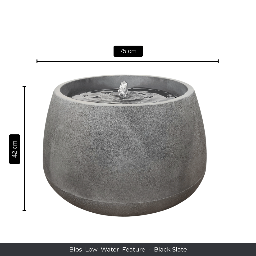 A round, black slate indoor fountain by Florastyle By Hingham. Measuring 75cm wide and 42cm tall, it adds tranquility to any space. Text at the bottom reads: Water Feature - Bios Low - Black Slate. Made from polyresin, durable and waterproof, yet lightweight. Suitable for indoor and outdoor spaces.
Colour: Black Slate
Price: R5195