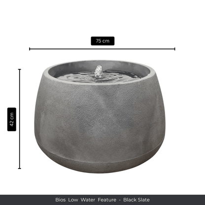 A round, black slate indoor fountain by Florastyle By Hingham. Measuring 75cm wide and 42cm tall, it adds tranquility to any space. Text at the bottom reads: Water Feature - Bios Low - Black Slate. Made from polyresin, durable and waterproof, yet lightweight. Suitable for indoor and outdoor spaces.
Colour: Black Slate
Price: R5195