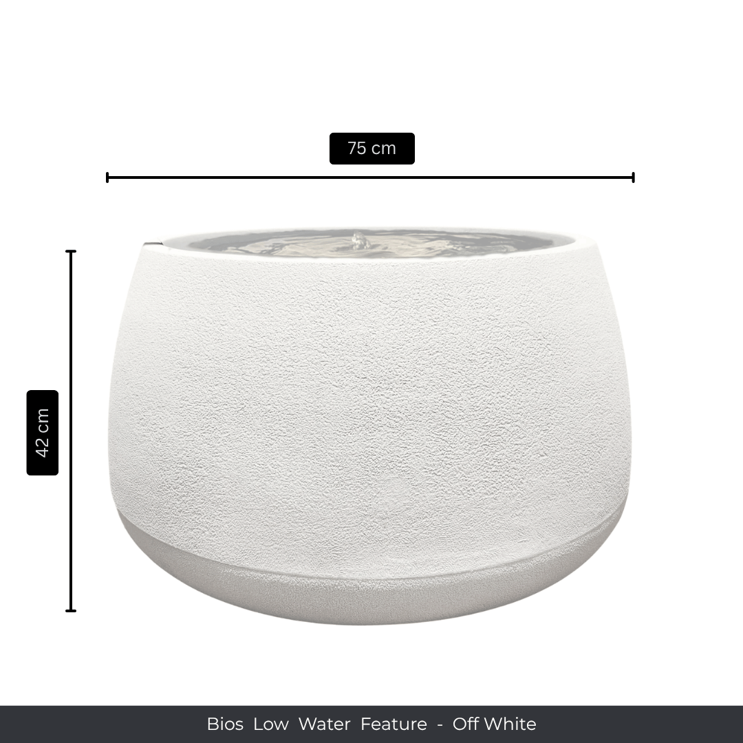 A round, off-white textured indoor fountain with a wide bowl (75 cm diameter, 42 cm height), filled with water. Text below reads: Water Feature - Bios Low by Florastyle By Hingham. Made from polyresin, durable and waterproof, yet lightweight. Suitable for indoor and outdoor spaces.
Colour: Off White
Price: R5195