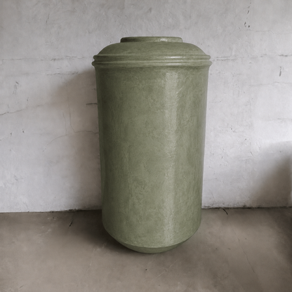 The Damascus Organic Fiberglass Pot - Earth Range by Florastyle By Hingham features a tall, cylindrical shape with a textured surface and rounded lid, making it a striking modern interior planter for any room.