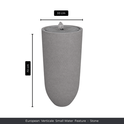 A tall, cylindrical stone water fountain by Florastyle By Hingham, 70 cm high and 33 cm in diameter, features a small upper fountain. Text below: Water Feature - European Verticale Small. Made from polyresin, durable and waterproof, yet lightweight. Suitable for indoor and outdoor spaces.
Colour: Stone
Price: R3465