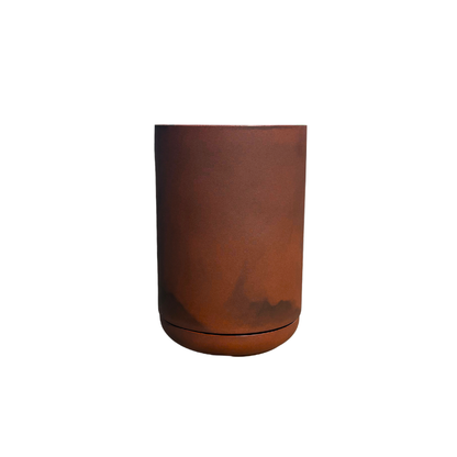 The Florastyle By Hingham Match Cylinder Japi Planter With Saucer is a cylindrical, reddish-brown ceramic pot with a matching saucer, styled in a modern design and shown against a plain white background.