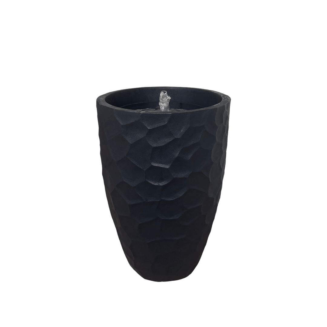 The Florastyle By Hingham Water Feature - Prisma Conic Medium is a tall, black (Lead) polyresin piece with a modern geometric textured pattern and bubbling water from the central top opening, set against a plain white background. Made from polyresin, durable and waterproof, yet lightweight. Suitable for indoor and outdoor.
Colour: Lead
Price: R3095