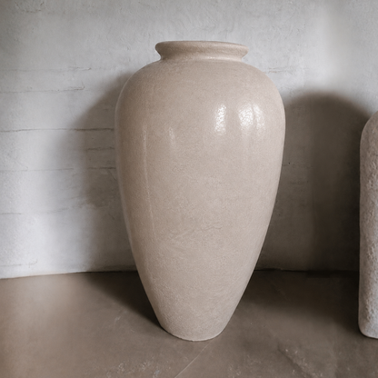 The Rhodes Organic Fiberglass Pot - Earth Range by Florastyle By Hingham features a large, beige, textured finish reminiscent of ceramic planters, with a wide body and narrow opening—perfect for minimal, modern spaces.