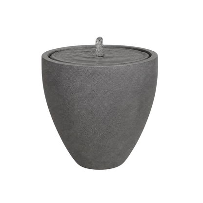 The Water Feature - Rustic Ellipse Small by Florastyle By Hingham is a modern, round gray stone outdoor fountain with a textured surface and central bubbling stream—perfect for adding rustic charm to any space.