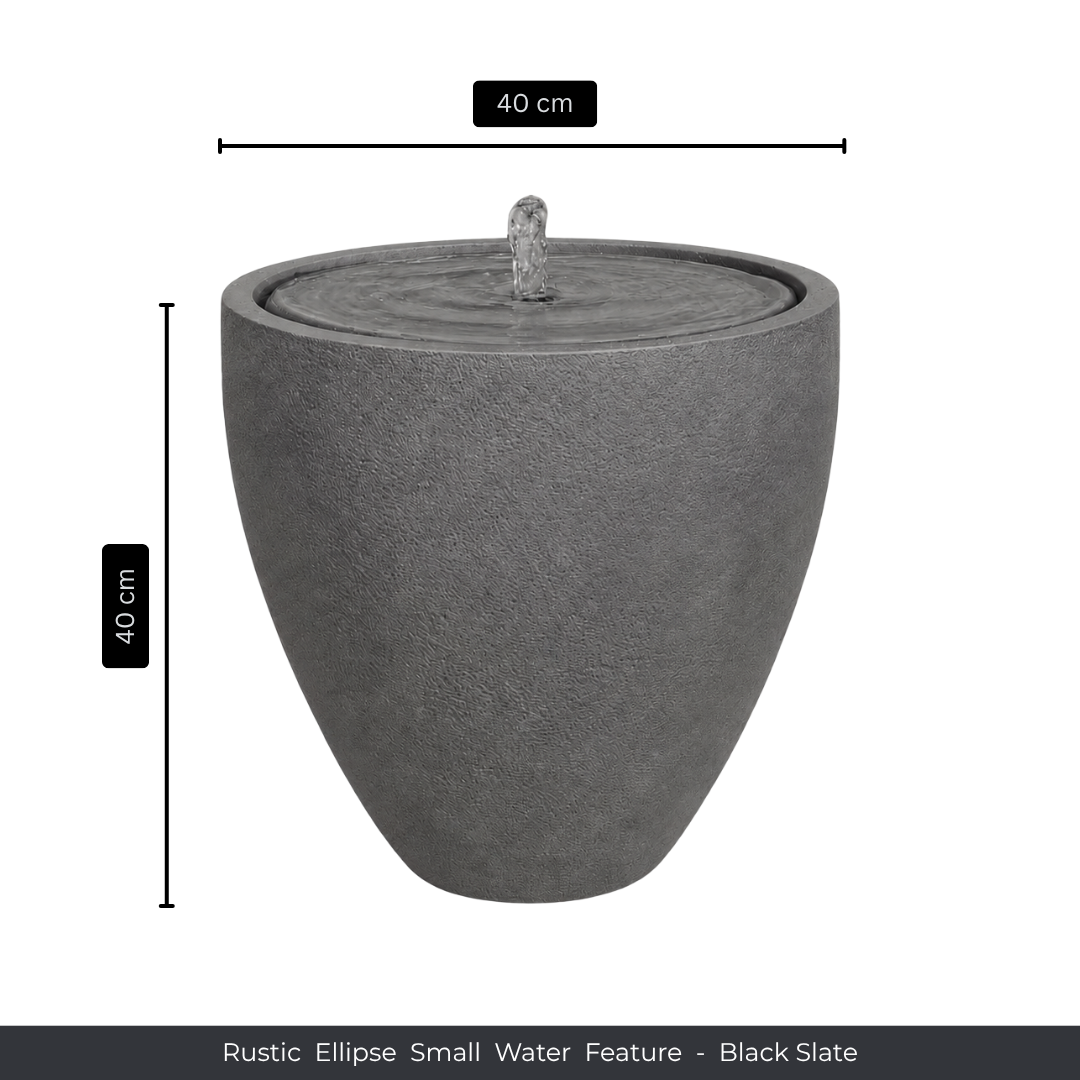 The Florastyle By Hingham Water Feature - Rustic Ellipse Small is a black slate, ellipse-shaped piece (40 cm high/wide) with gentle water flow, ideal for adding natural charm indoors or outdoors.