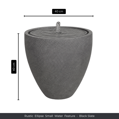 The Florastyle By Hingham Water Feature - Rustic Ellipse Small is a black slate, ellipse-shaped piece (40 cm high/wide) with gentle water flow, ideal for adding natural charm indoors or outdoors.