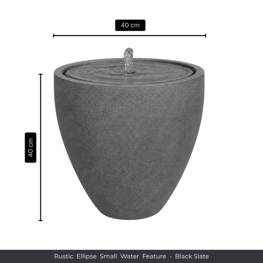 The Florastyle By Hingham Water Feature - Rustic Ellipse Small is a black slate, ellipse-shaped piece (40 cm high/wide) with gentle water flow, ideal for adding natural charm indoors or outdoors.