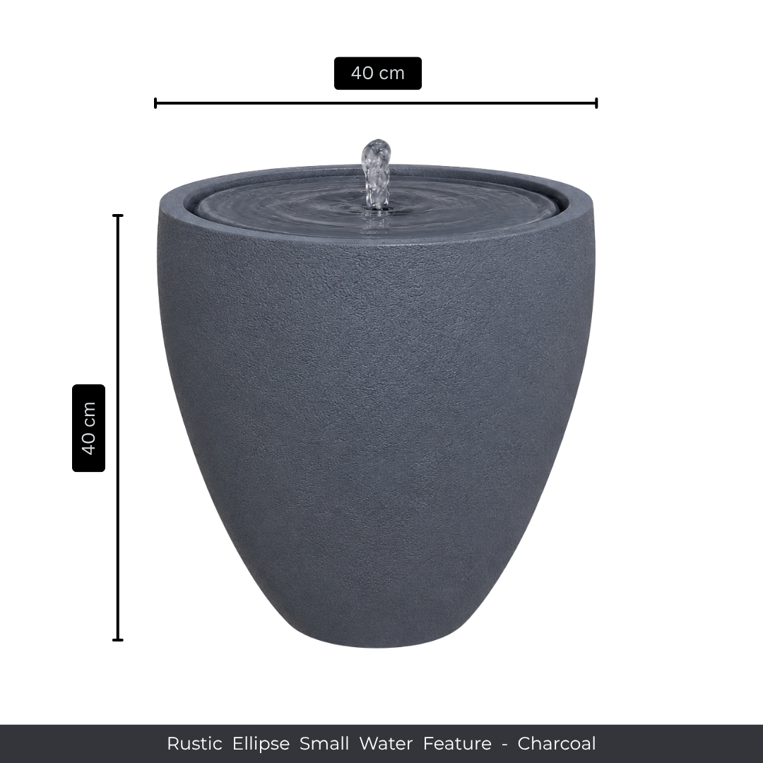 The Florastyle By Hingham Water Feature - Rustic Ellipse Small has a charcoal rustic finish, gently bubbling water at the top, and stands 40cm tall by 40cm wide—ideal for adding charm to indoor or outdoor spaces.