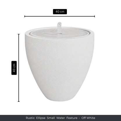 The Florastyle By Hingham Water Feature - Rustic Ellipse Small is an off-white, ellipse-shaped fountain (40x40cm) that adds tranquil charm indoors or outdoors with its central spout and rustic design.