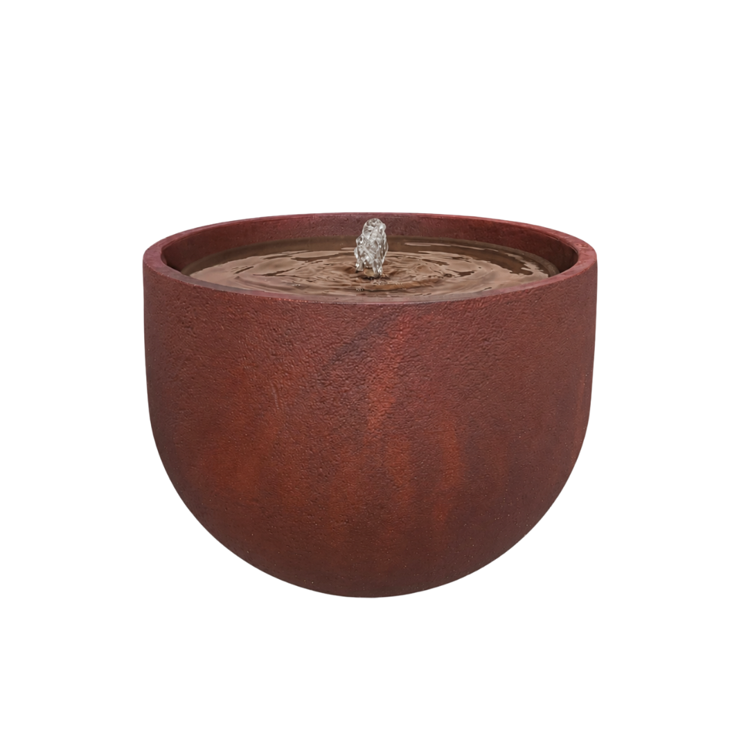 The Florastyle By Hingham Water Feature - Rustic Round is a rust-colored, bowl-shaped polyresin fountain with a central spout, creating gentle ripples and standing out beautifully against a plain white background.