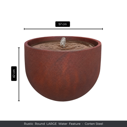 The Florastyle By Hingham Water Feature - Rustic Round is a large, rust-colored corten steel piece (57 cm wide, 42 cm high) with water gently bubbling from the center. Pairs beautifully with Japi planters for a striking garden display.