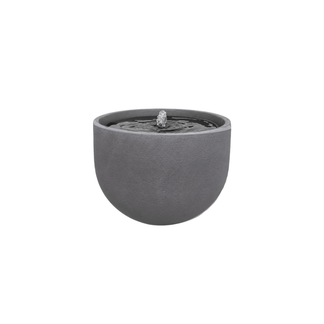 The Florastyle By Hingham Water Feature - Rustic Round is a modern gray polyresin garden fountain with a smooth surface. Water gently bubbles from the center, creating ripples on its UV-resistant design, shown against a plain white background. Made from polyresin, durable and waterproof, yet lightweight. Suitable for indoor and outdoor spaces.
Colour: Black Slate
Price: R1495