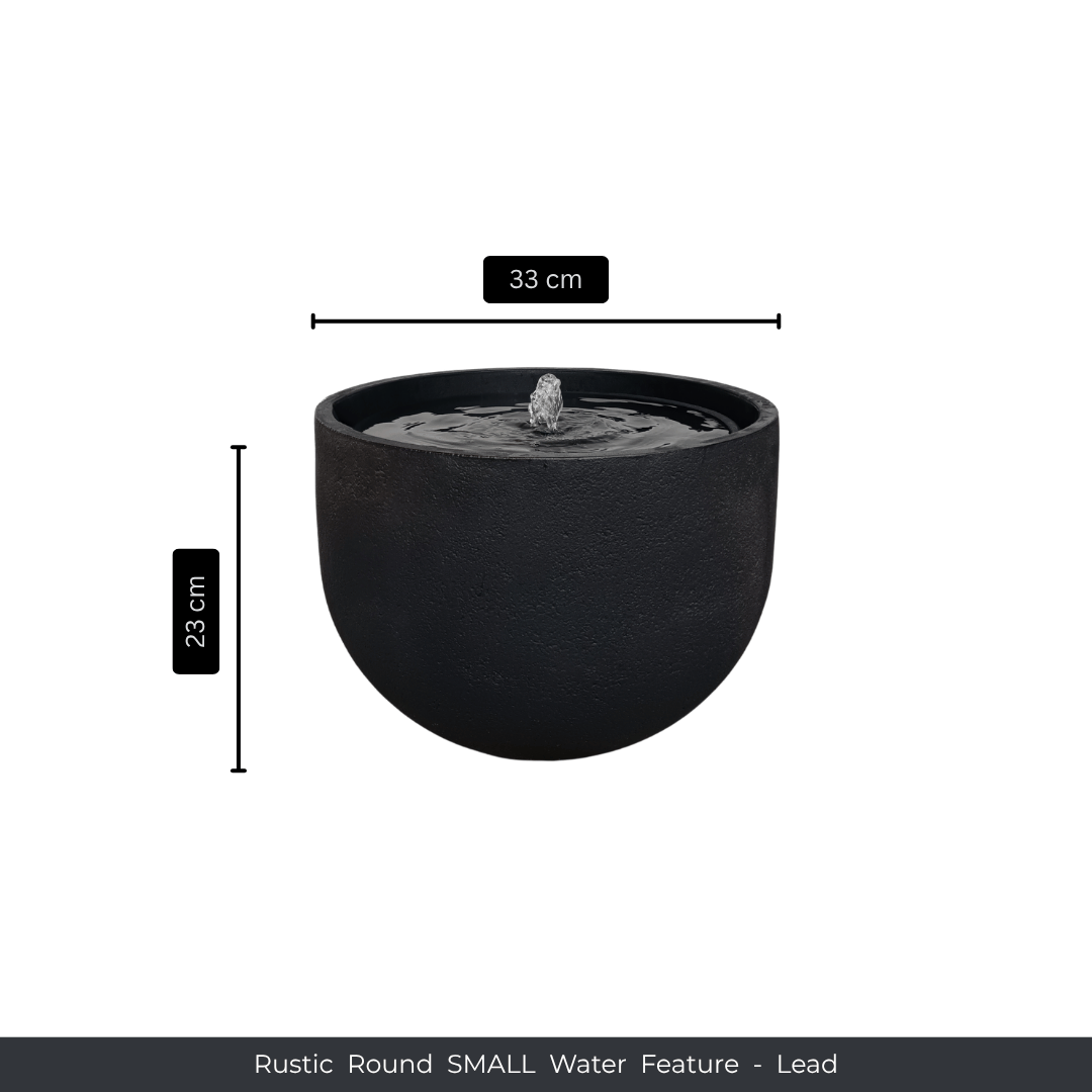 A round, black Water Feature - Rustic Round by Florastyle By Hingham, featuring a small central fountain. Measures 33 cm wide and 23 cm tall. Made from UV-resistant polyresin. Text: Water Feature - Rustic Round SMALL - Lead. Made from polyresin, durable and waterproof, yet lightweight. Suitable for indoor and outdoor spaces.
Colour: Lead
Price: R1495