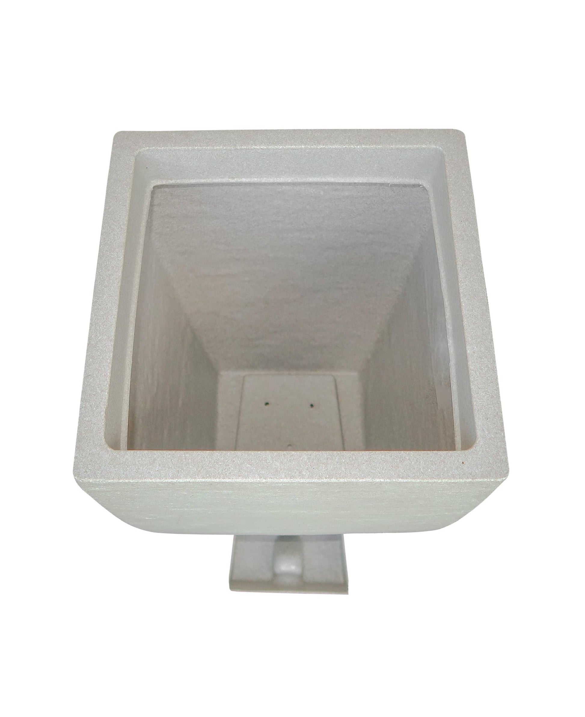 Aerial view showing the drip tray housing and the drip tray in a slide out position outside of the planter.