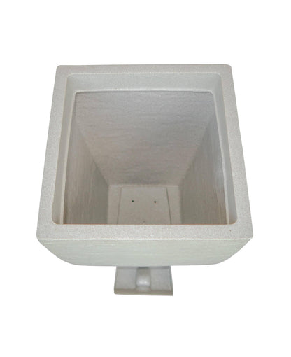 Aerial view showing the drip tray housing and the drip tray in a slide out position outside of the planter.